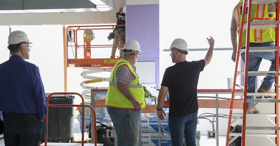 Construction team discussing work inside an active project