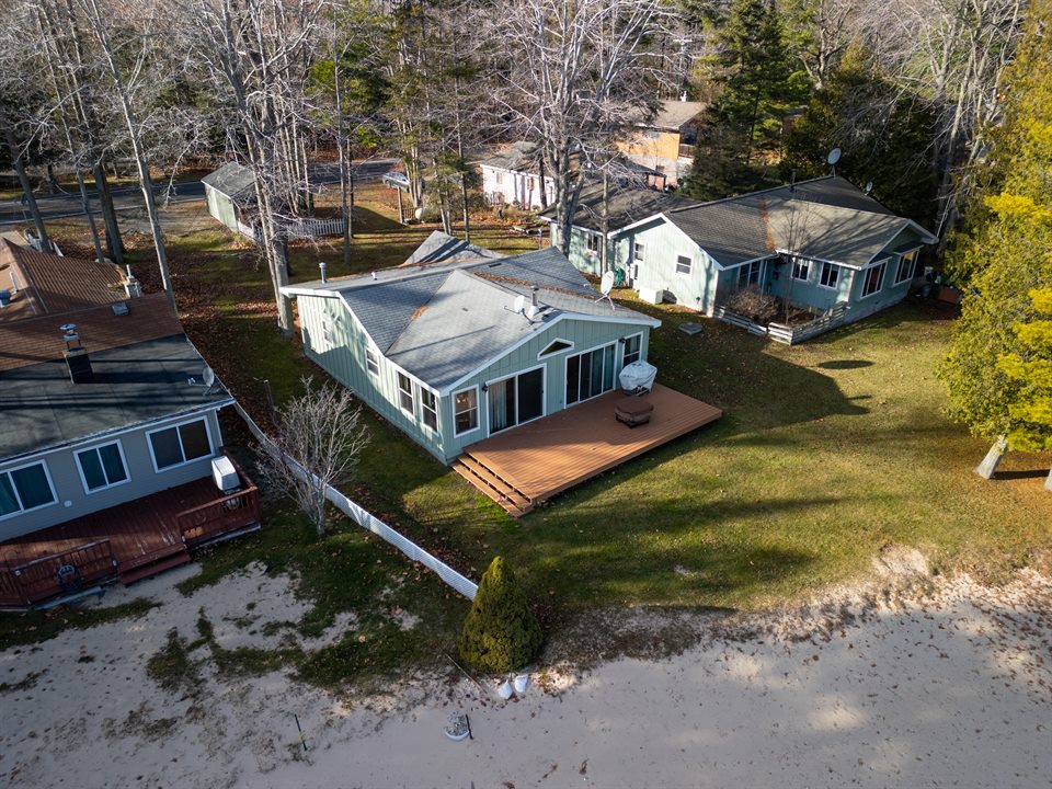 Lakefront cottage within its wooded shoreline setting